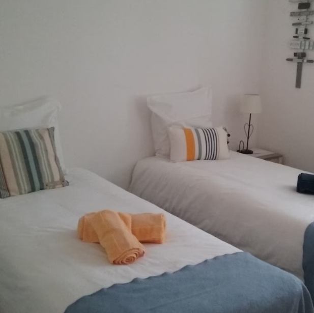 Schlafzimmer mit zwei Einzelbetten und Handtüchern